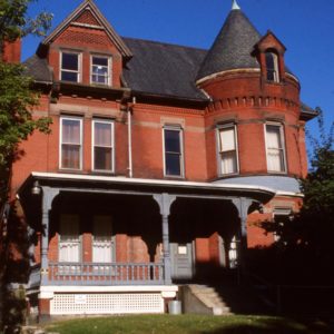 Queen Anne home with fine detail in the brickwork including the massive turret. 