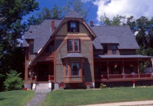 A deeply tinted multi-color paint scheme pulls out the architectural beauty on this stick style home