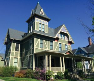 A wonderful Stick-style house with a later Colonial revival porch.