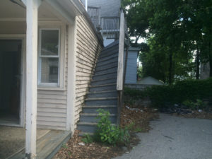 Leaning staircase before Massachusetts Housing Initiative rehab. 