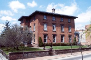 A three story brick Italianate style home