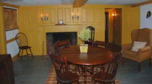 Raised panel fireplace mantle painted a mustard gold.