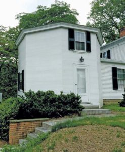 An octagonal building attached to the main house by an ell addition.