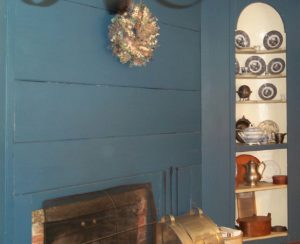 Prussian Blue fireplace wall and corner cupboard.