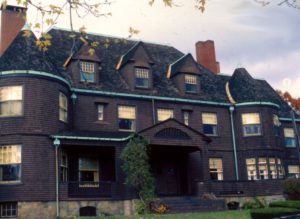 This massive shingle style house features oversized windows and classic style.