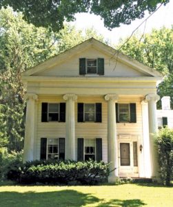 Classic Temple front Greek Revival with Ionic topped columns.