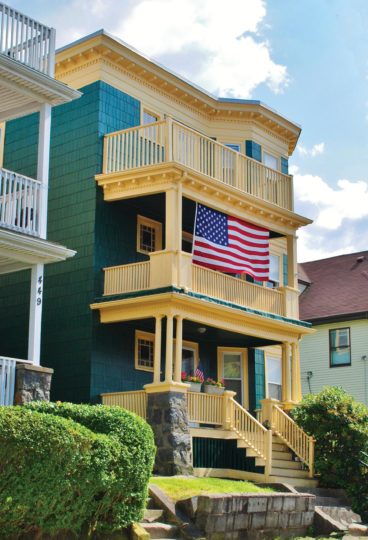 Colorful triple decker with American flag.