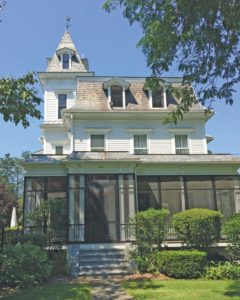 House with a concave Mansard roof with "Witches Hat" tower.