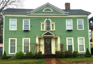 Early elegant Federal style home with dormers and Palladian window addition confuses the style. 